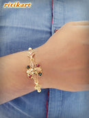 Royal Green and Red Stone Golden Metal Rakhi