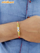 Designer Crystal with Golden and Green Beads Rakhi